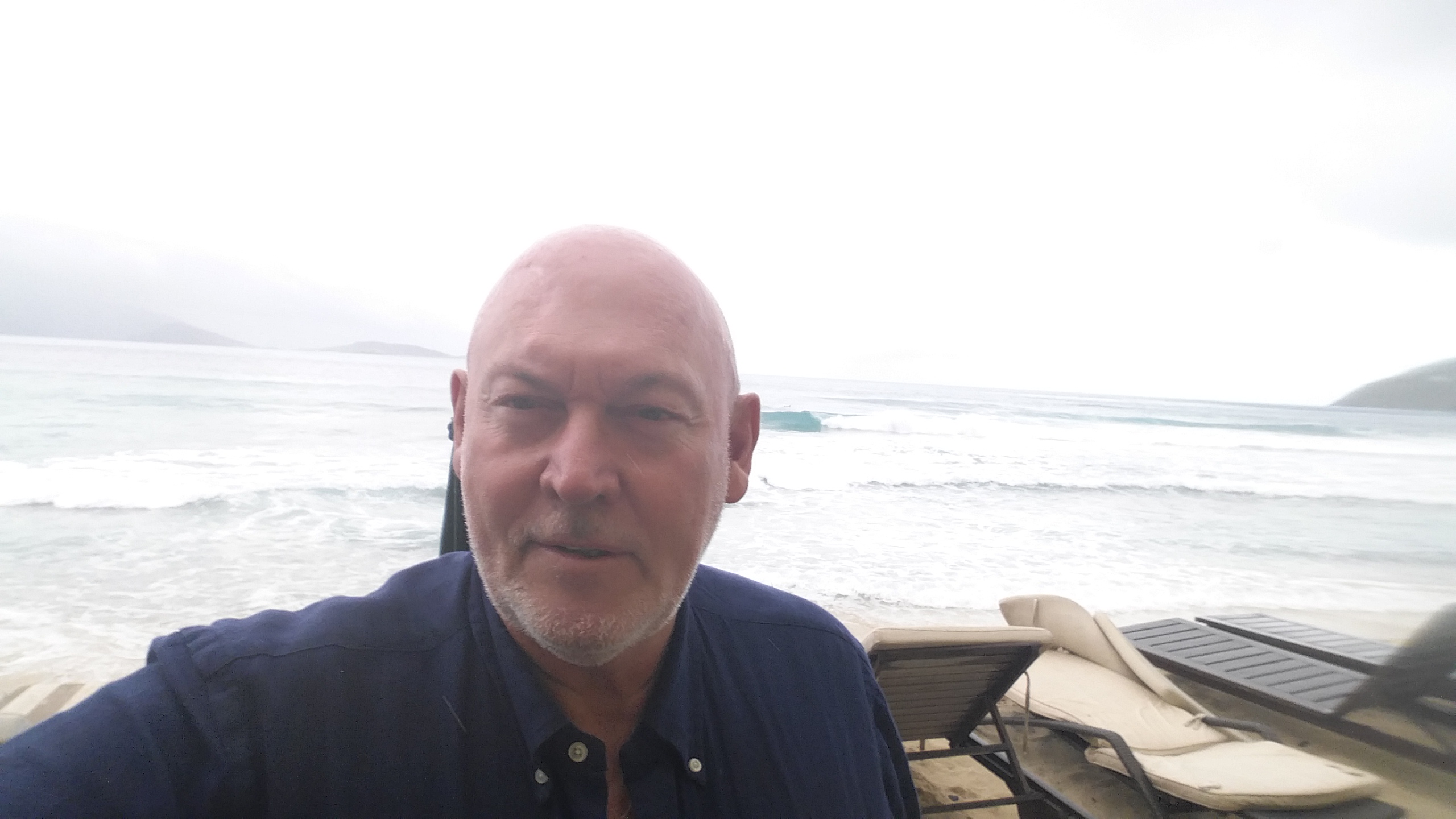 Jonathan at Cane Garden Bay, Tortola, BVI in 2019 looking at a small rideable strong right handed surf break.